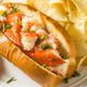 Connecticut style lobster roll with butter on plate